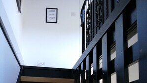 A staircase with wooden steps and a black metal railing with square cutouts. - The Annexe at Loch View Farm will take your breath away (Crieff)