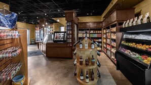 A grocery store interior with a central display of wine bottles, shelves stocked with various products, and a refrigerated section on the right. - 2 BD/2 BA Beach Front Marriott Frenchman's Cove Condo St Thomas...SLEEPS 8! (St Thomas)