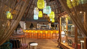An interior with a bar area, wooden flooring, and hanging lanterns. - Vidanta Mayan Palace 2 bedroom 2 Bath  (Riveria Maya)