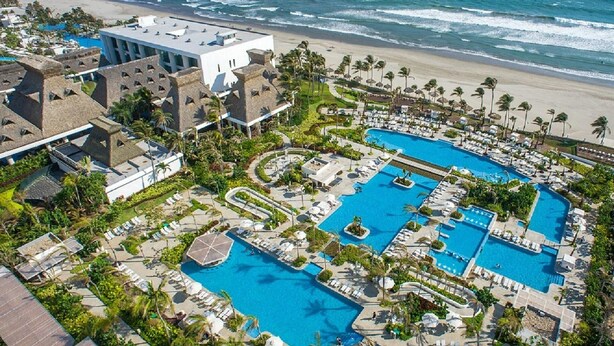 A resort with multiple swimming pools, beachfront views, and palm trees. - Mayan Palace Acapulco (Acapulco, Guerrero)
