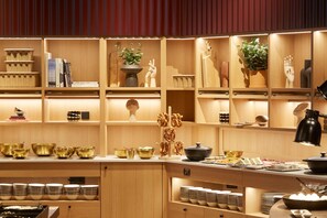 A well-organized buffet area with various dishes and serving ware. - Scandic München Macherei (Munich)