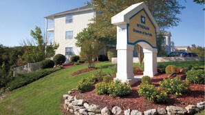 A sign for Wyndham Branson at the Falls, a modern building with a white facade and a landscaped garden area. - Enjoy the Scenery & Attractions of Branson! Sept 4th - 11th (Branson)