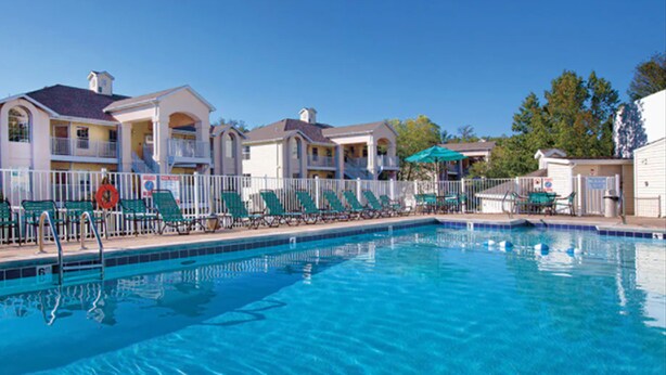 A swimming pool with lounge chairs and a fence. - Enjoy the Scenery & Attractions of Branson! Sept 4th - 11th (Branson)