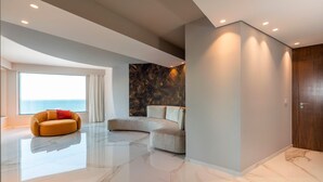 A modern interior with a curved sofa, a large window with a view, and a marble floor. - Luxury villa with pool, sea view, 20 pax, Giardini Naxos, Sicily (Giardini-Naxos)