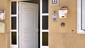 A door with a number '4' sign above it, a mailbox, and a small outdoor light fixture.