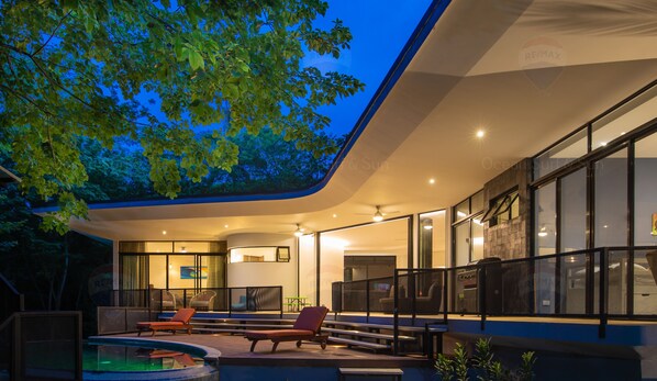A modern house with a swimming pool, outdoor seating, and large windows. - Tamarindo, Senderos Gated Community Oasis. (Tamarindo)