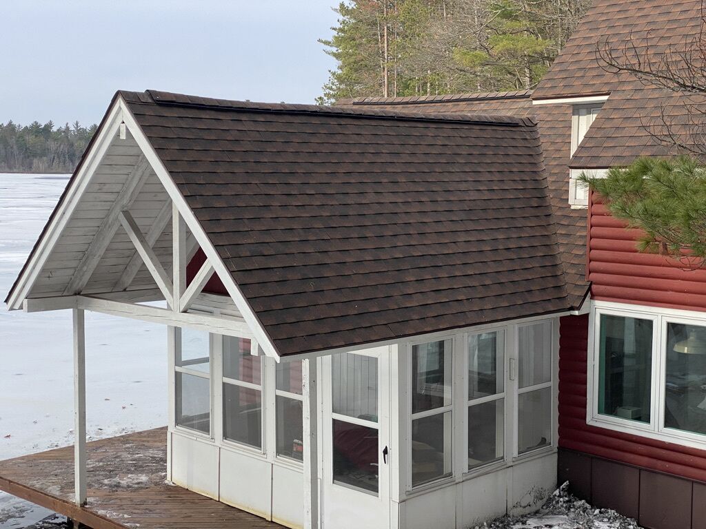 A small, single-story house with a gabled roof and a covered porch.