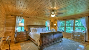 A wooden cabin bedroom with a bed, dresser, and desk. - Stunning Mountain Cabin w/ Pool Table, Hot Tub, Wifi, 20 min to Blue Ridge (Blue Ridge)