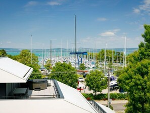 Overlooking a serene marina, this waterfront property offers stunning views of sailboats docked in a well-organized harbor.