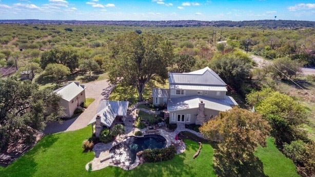 A large house with a spacious backyard, a swimming pool, and a well-maintained lawn. - Historic 1906, 15 acre Ranch with pool 20 minutes from SeaWorld (San Antonio)