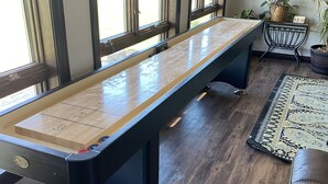 A pool table in a room with large windows, a rug, and a potted plant. - All Amenities!  Salt water hot tub!  Walking trail!  In town! (Spearfish)