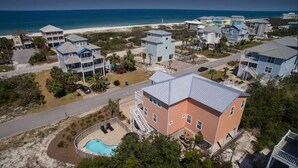 A coastal residential area with houses, a swimming pool, and a beach in the background. - Dates Available!!  Check out our property!! (Port St Joe)