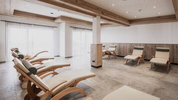 Relax in a serene space with a series of massage chairs and high ceilings.