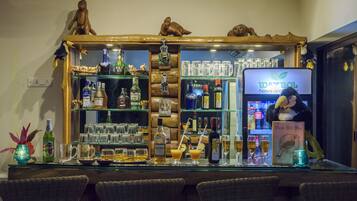 A bar area with a variety of liquor bottles, glasses, and a sign for Waybol hotels.