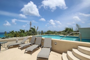 A rooftop pool, pool loungers