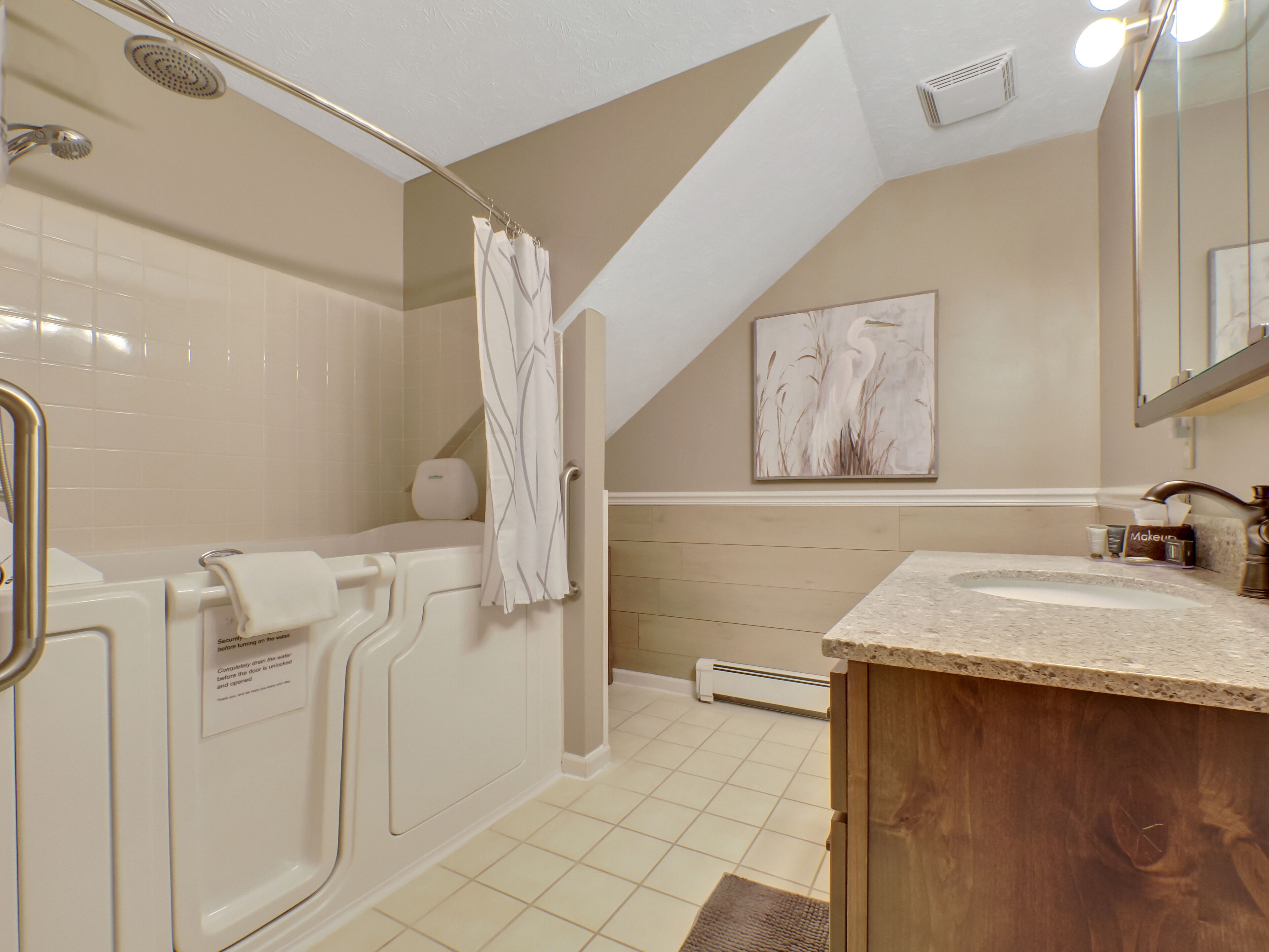 A modern bathroom with a walk-in shower, a bathtub, and a vanity with a sink.
