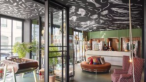 A modern interior with a foosball table, a round seating area, and a bar counter. - Mama Shelter Lisboa  (Lisbon)