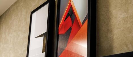 Two framed artworks on a wall.