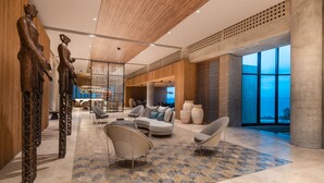 A spacious lobby with modern furniture, large windows, and decorative sculptures. - Sofitel Barú Cartagena (Cartagena)