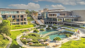 A modern hotel with multiple buildings, a swimming pool, and lush landscaping. - Sofitel Barú Cartagena (Cartagena)