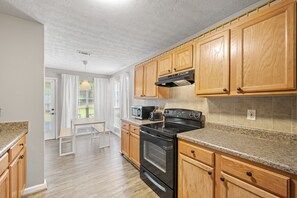 Microwave, dishwasher, coffee/tea maker, cookware/dishes/utensils