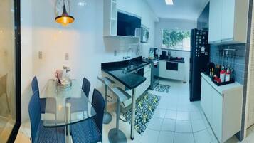 Enjoy meals in the kitchen with a dining area featuring a table and chairs.