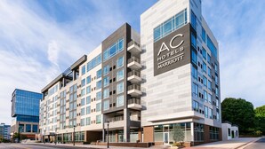 A multi-story hotel with a modern design, featuring a prominent sign for AC Hotels Marriott. - AC Hotel by Marriott Raleigh Downtown (Raleigh)