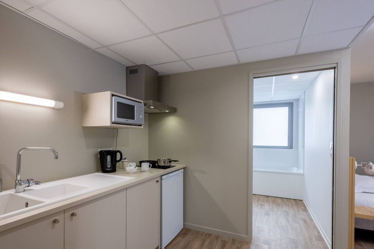 studio suite | premium bedding, desk, laptop workspace, soundproofing