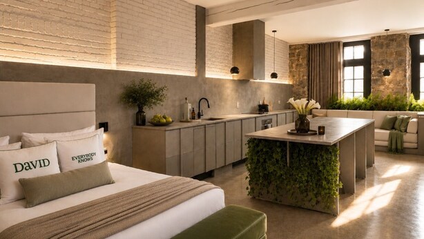 A modern hotel room with a large bed, a kitchen area, and a seating area with a view. - David Hotel (Montreal)
