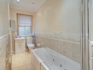 A bathroom with a bathtub, toilet, sink, and shower area. - 2 bedroom accommodation in Watermillock (Watermillock)