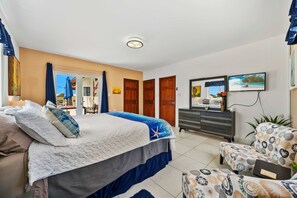 A bedroom with a bed, dresser, chair, and a TV. - Beautiful Villa with New Private Pool (Savaneta)