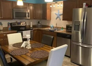 Enjoy cooking and dining in this fully equipped kitchen with a dining table for four.