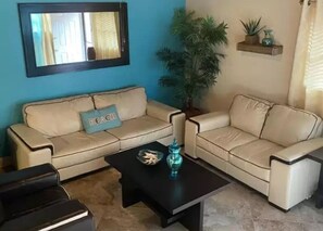 Relax in this stylish living room with two sofas, a coffee table, and a large mirror.