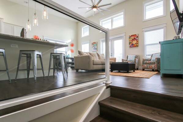 A spacious living area with a kitchen, a staircase, and a dining area.