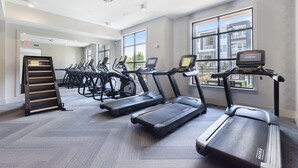A gym with treadmills, a stair climber, and a rowing machine. - Luxury Apt | Work from here | King Bed | Fast WiFi |6mi to CLT✈️ (Charlotte)