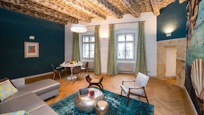 A living room with a sofa, chairs, a coffee table, and a fireplace. - Old Royal Post Apartments (Prague)
