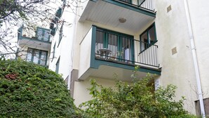 A multi-story residential building with balconies, a white exterior, and a green railing. - Pine Rigg - Quarry Rigg (Bowness-on-Windermere)