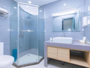 A modern bathroom with a glass shower enclosure, a white sink, and a mirror above the vanity. - Greentree Inn Chongqing Longhushidai Tianjie Xietaizi Subway Station H (Chongqing)