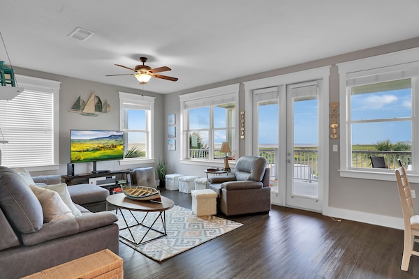 Great room concept with great bay views out a wall of windows.
