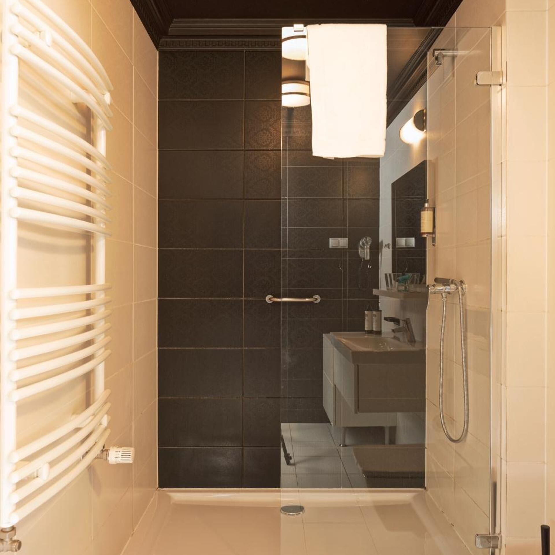 A bathroom with a shower, a toilet, and a sink.