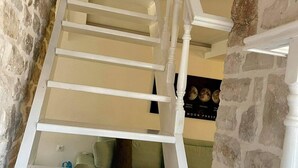 A staircase with white railings leading to a landing.