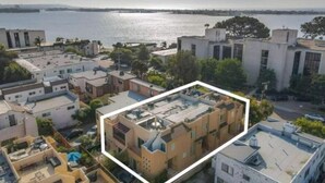A residential area with buildings overlooking a body of water.