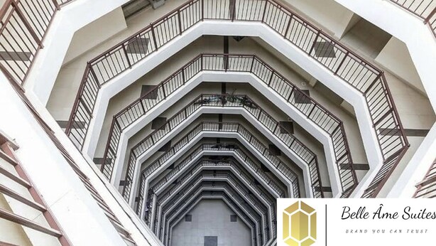 A multi-level interior with a central staircase surrounded by balconies.