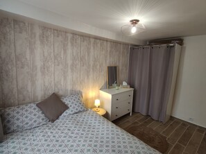 Relax in a stylish room with a large bed, bedside table, and mirror.