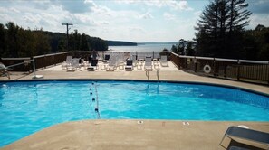 Relax by the pool surrounded by a serene natural landscape.