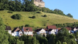 A hilltop house with a traditional design, surrounded by a residential area with houses. - Am Dohlenberg + Steintisch by Interhome (Schwalenberg)