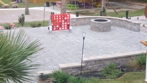 A playground with a slide, swings, and a covered picnic area.