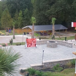 A playground with a slide, swings, and a covered picnic area. - Affordable Fun House (Rock Hill)