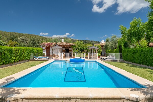 A rectangular swimming pool with a blue mosaic pattern, surrounded by a white fence, with a small gazebo and lounge chairs in the background. - Villa la Rafal with Mountain View, Pool, Wi-Fi, A/C, Terrace & Garden (Pollensa)