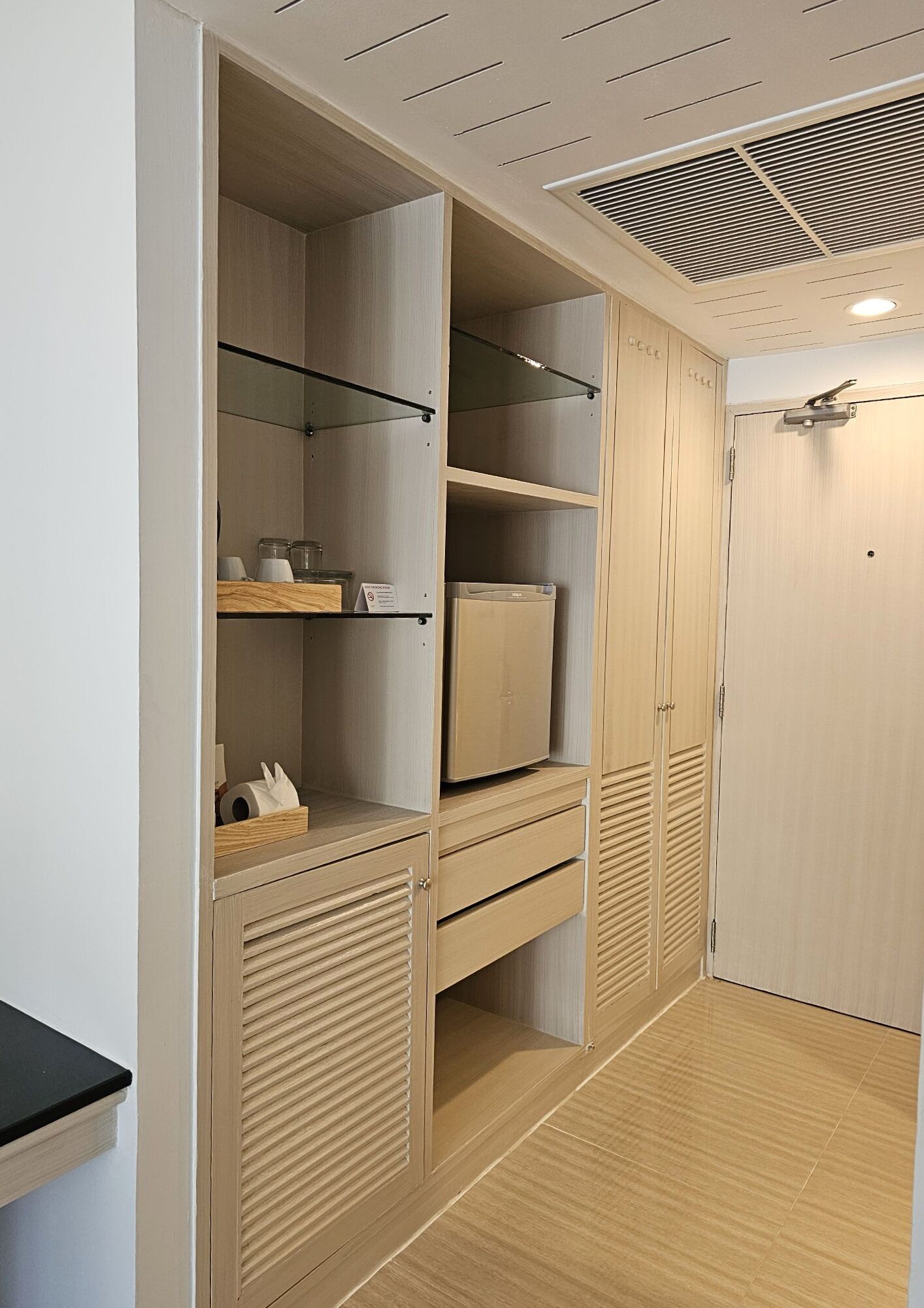 A modern, well-organized closet with multiple shelves, drawers, and a built-in heater.